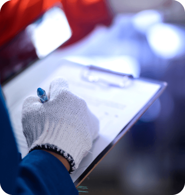 Hand writing a report on a notepad